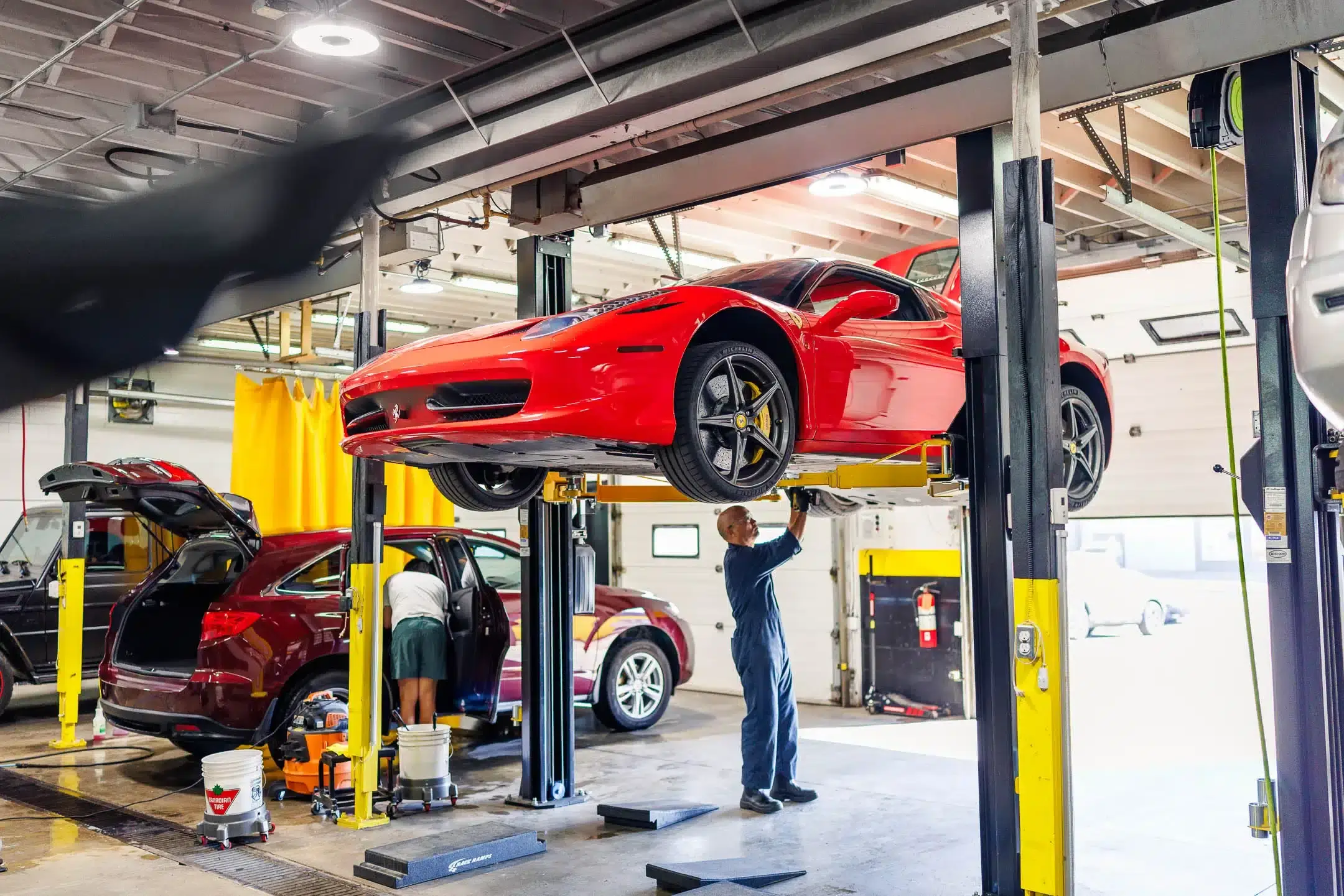 Master mechanic performing car repair workshop in Dubai auto car maintenance