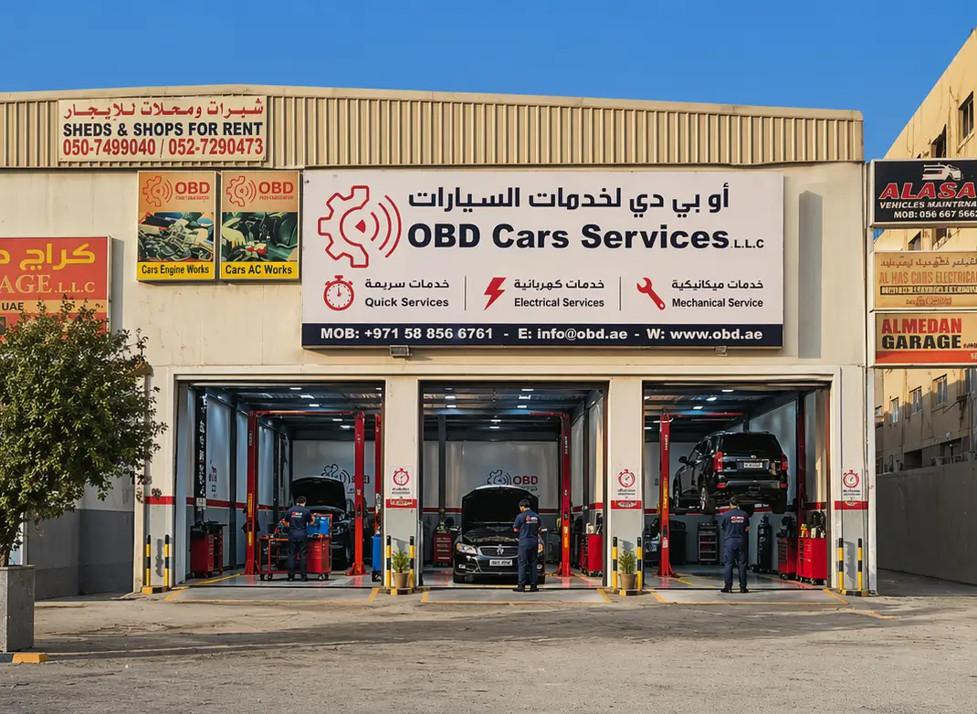 Master Mechanic repairing car engine wearing uniform with OBD logo at Car Workshop UAE